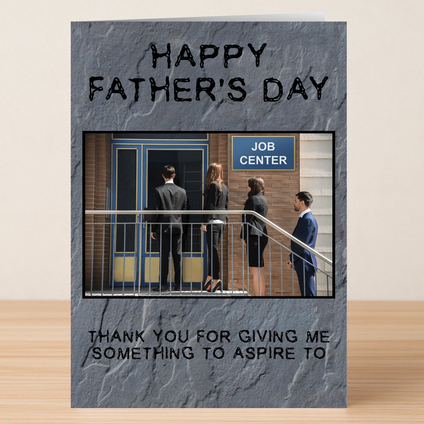 The Aspire Insulting Father's Day Card by Twisted Gifts features four business people lining up outside a job center with the message, "Thank you for giving me something to aspire to." A darkly humorous and unique Father's Day card.