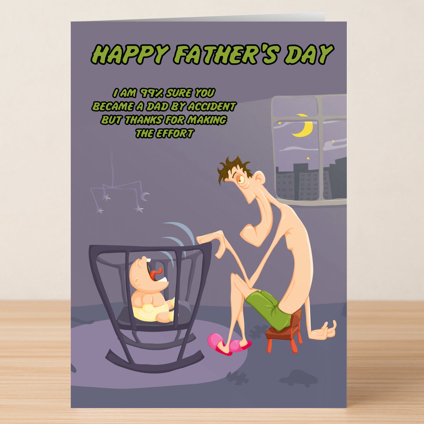 The Twisted Gifts Accidental Dad Rude Father's Day Card humorously shows a dad in underwear and slippers calming a crying baby, with playful text about accidental parenthood.