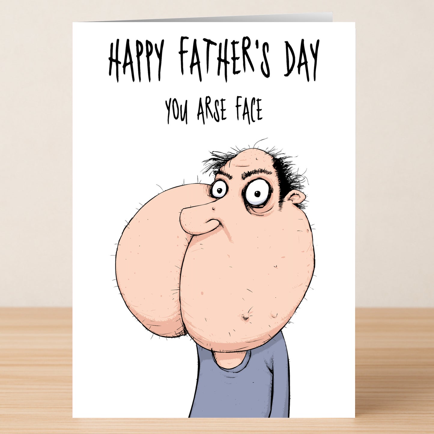 The Twisted Gifts Arse Face Insulting Father's Day Card features a cartoon man with exaggerated cheeks and the phrase "Happy Father's Day you arse face." Ideal for dads who enjoy dad jokes and edgy humor!.