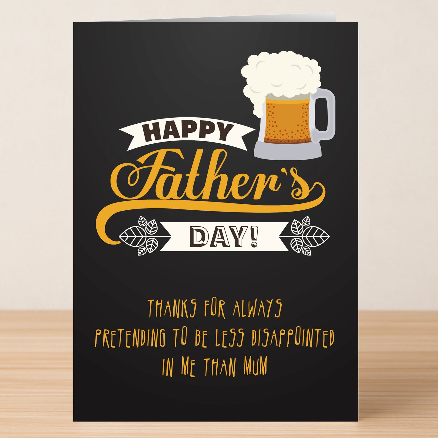 The Less Disappointed Funny Father's Day Card by Twisted Gifts features a beer mug and the message: "Happy Father's Day! Thanks for always pretending to be less disappointed in me than Mum." Ideal for dads with a quirky sense of humor.