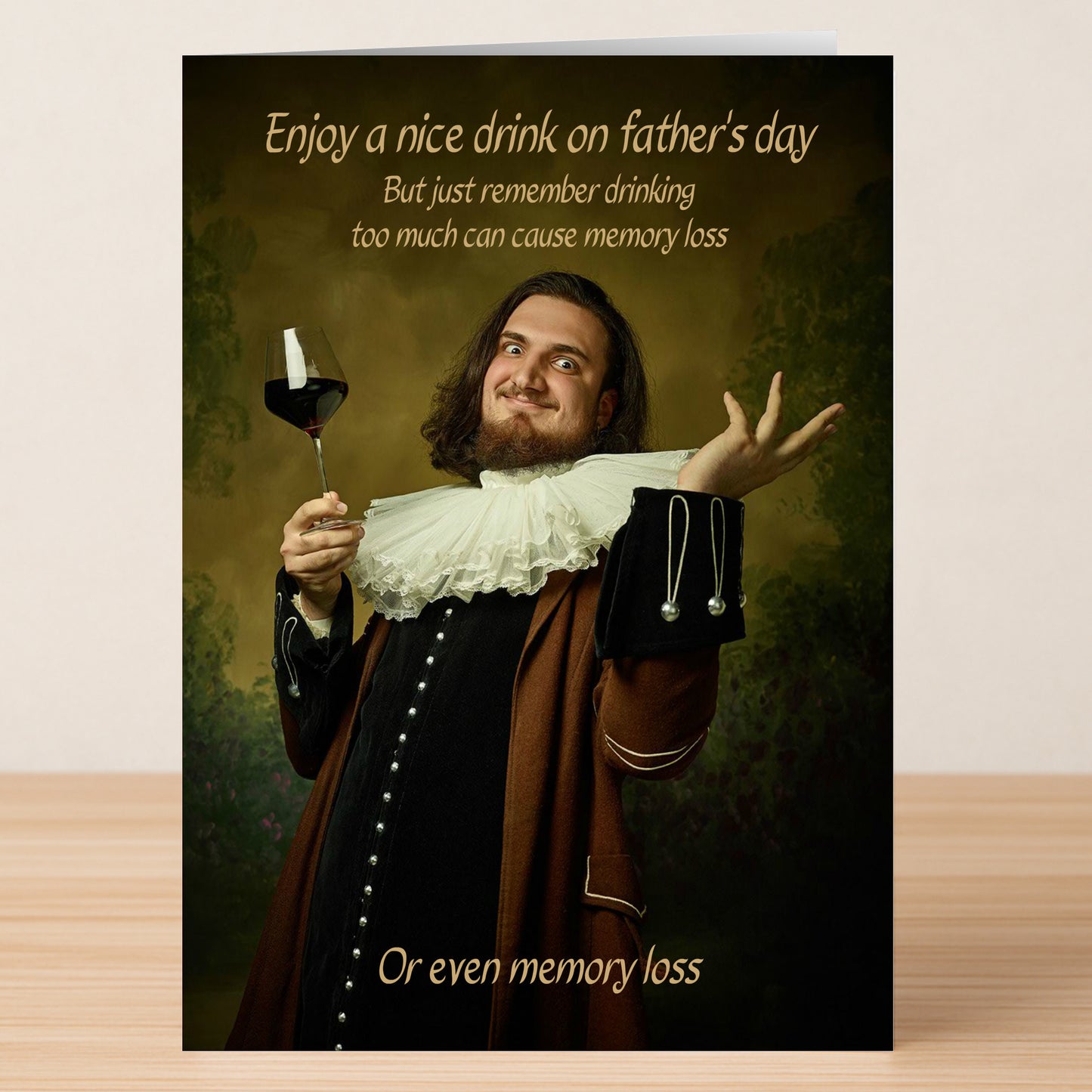 A man in historical attire holds a glass of wine and gestures dramatically on the Memory Loss Funny Father's Day Card by Twisted Gifts. Card reads: "Enjoy a nice drink... but remember, drinking too much can cause memory loss or even memory loss.