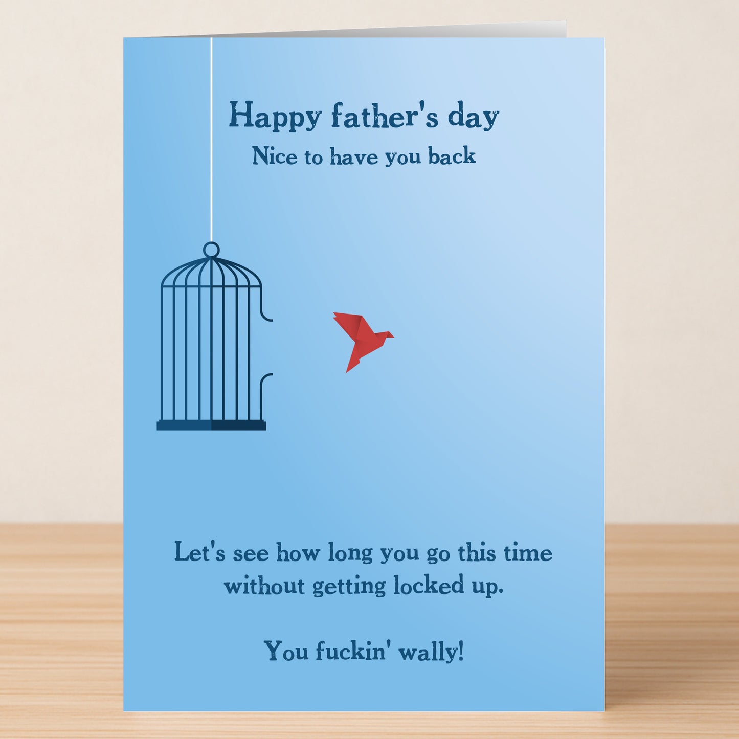 The Wally Funny Father's Day Card by Twisted Gifts features a blue design with a birdcage, flying red bird, and the cheeky message: "Happy Father's Day. Nice to have you back...without getting locked up. You fuckin' wally!.