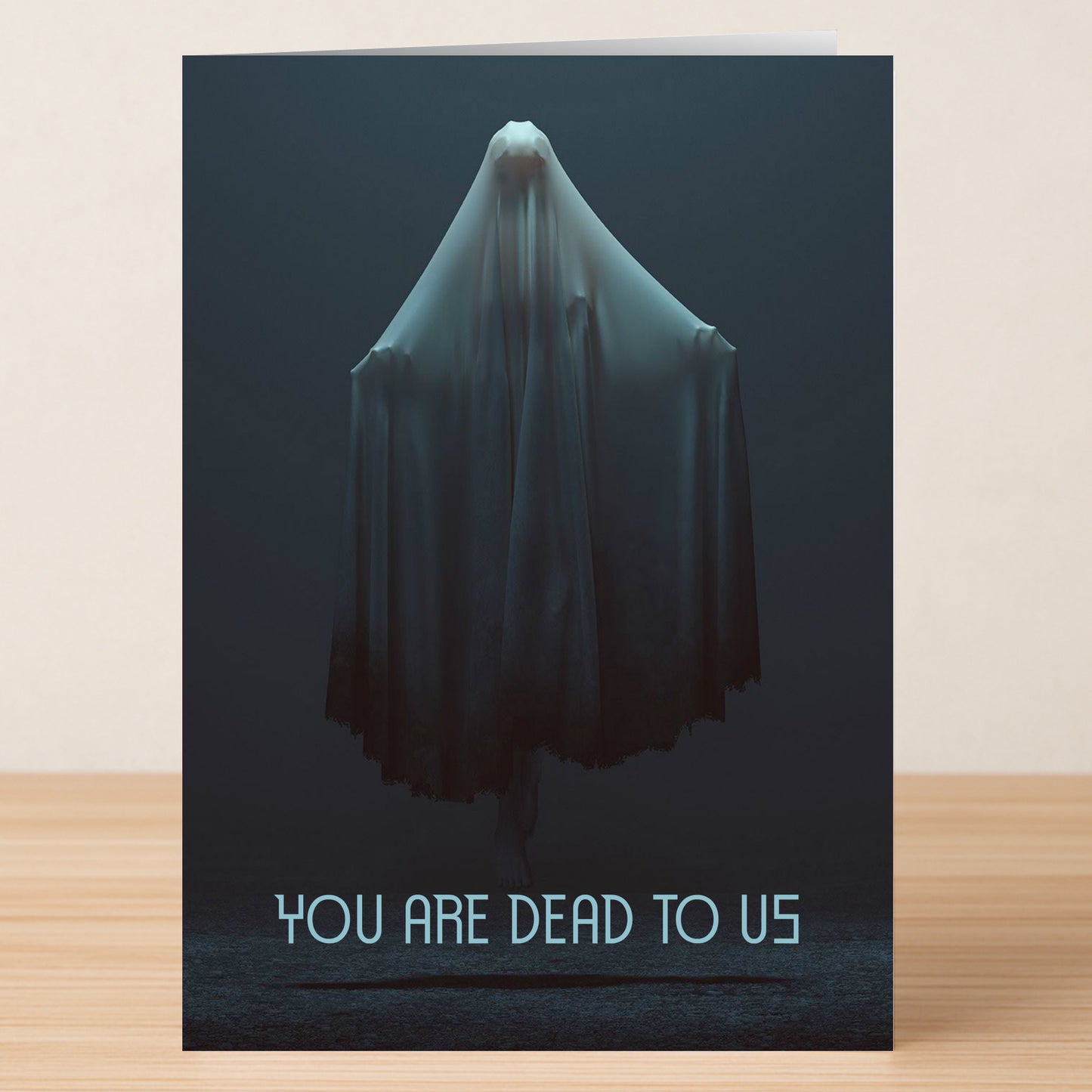 The Dead Insulting Farewell Card by Twisted Gifts features a ghost in a white sheet and the text "YOU ARE DEAD TO US," delivering humorous insults for a memorable, tongue-in-cheek sendoff.