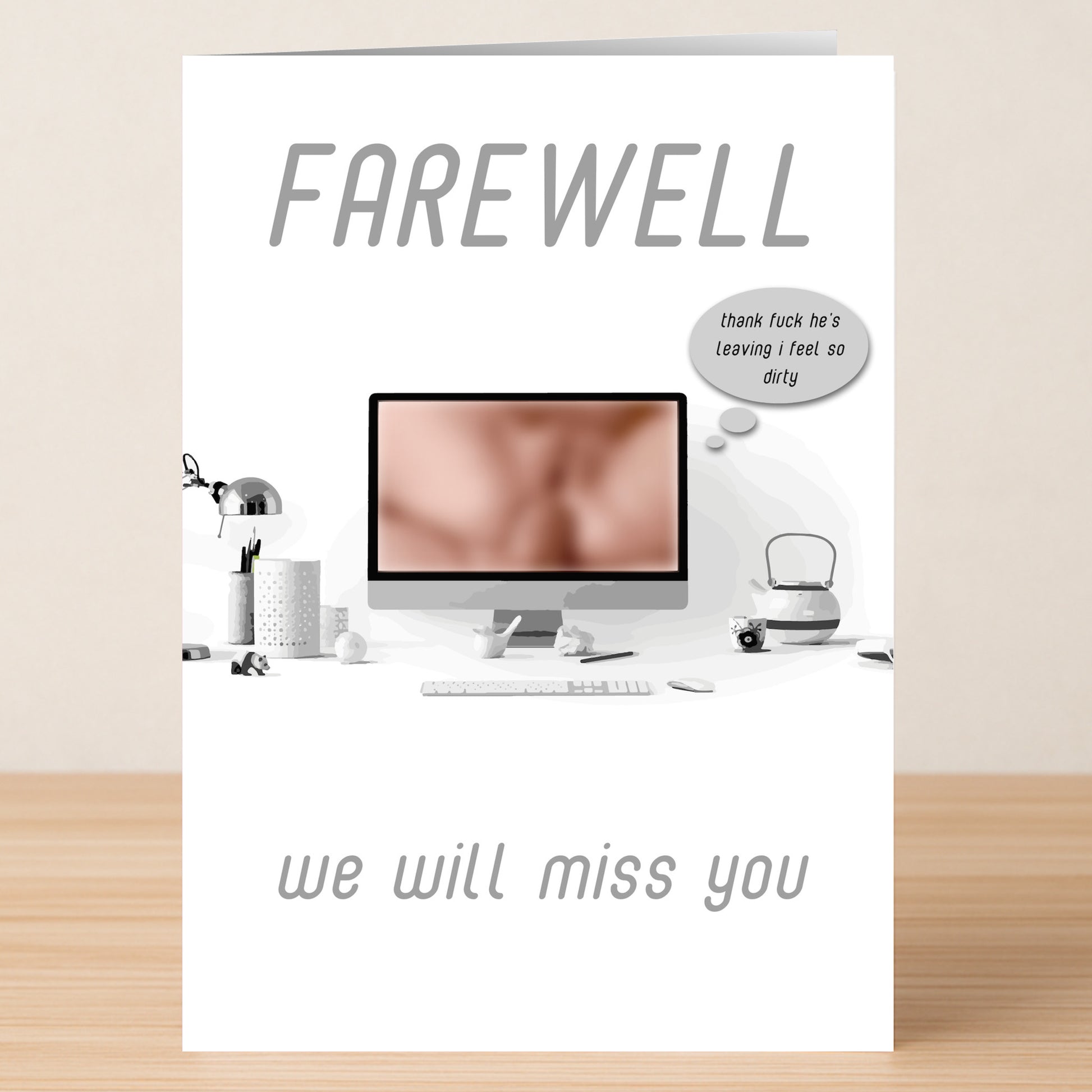 The Feeling Dirty Rude Farewell Card by Twisted Gifts sits on a desk with "FAREWELL" and "we will miss you" text plus a cheeky card touch—a blurred screen and a speech bubble with a feeling dirty, humorous message.