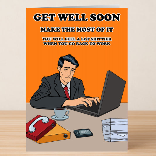 A tired man in a suit works at his desk with files, coffee, and tissues. The Twisted Gifts Make The Most Of It Rude Get Well Soon Card reads: "Get well soon. Brighten their day—they’ll feel much worse once they're back at work.