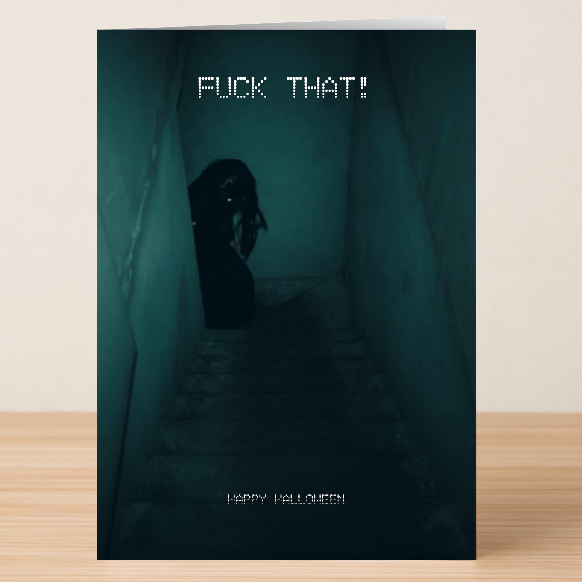 The Fuck That Funny Halloween Card by Twisted Gifts features a dim stairwell with a shadowy figure and bold text: "FUCK THAT!" on top and "HAPPY HALLOWEEN" at the bottom—a hilarious Halloween card for spooky fun.