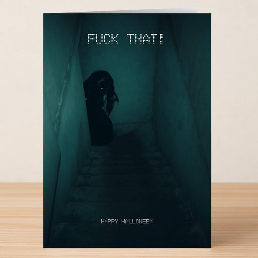 The Fuck That Funny Halloween Card by Twisted Gifts features a dim stairwell with a shadowy figure and bold text: "FUCK THAT!" on top and "HAPPY HALLOWEEN" at the bottom—a hilarious Halloween card for spooky fun.