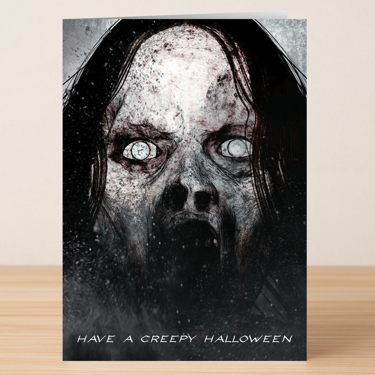The Creepy Funny Halloween Card by Twisted Gifts features a dark, ghostly face with hollow eyes and an open mouth, plus the message "Have a Creepy Halloween" at the bottom.
