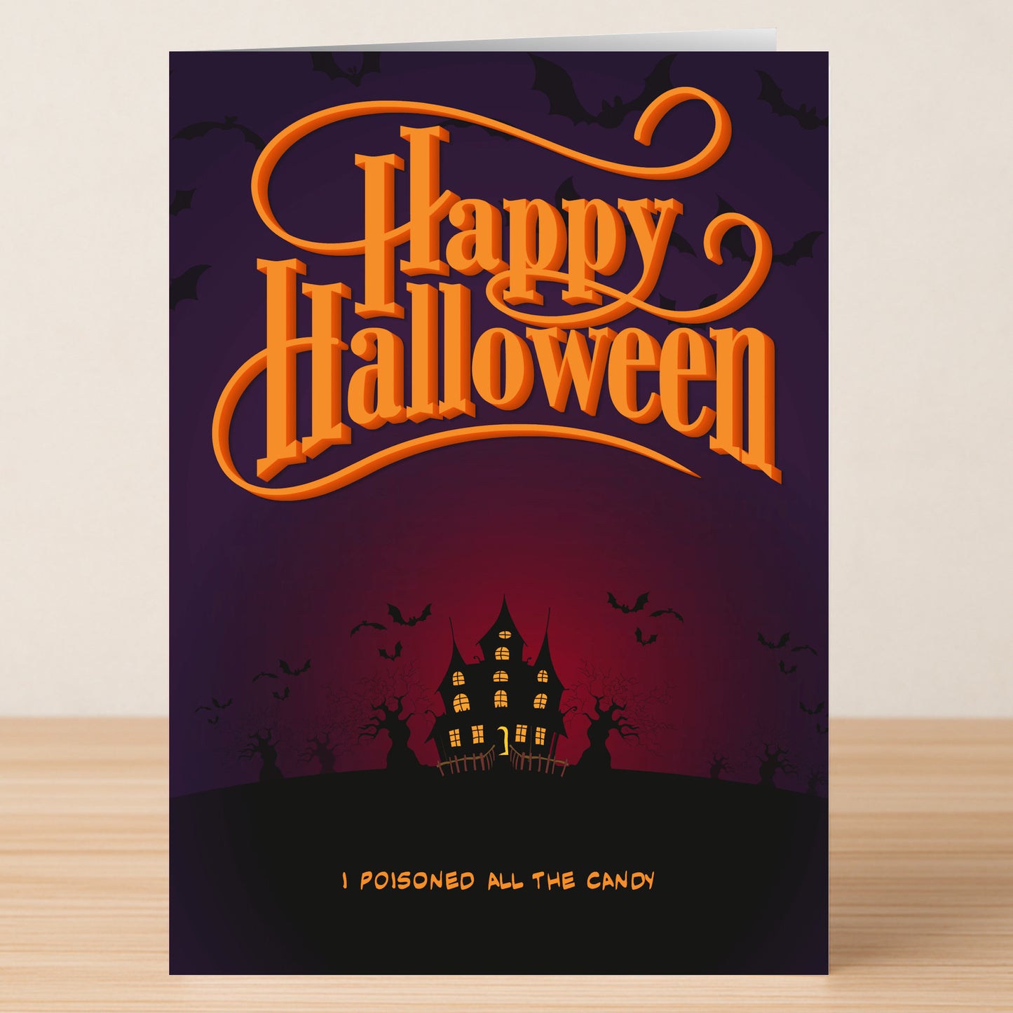 The Poisoned Funny Halloween Card by Twisted Gifts showcases "Happy Halloween" in bold orange, a haunted house, bats, and the playful line "I poisoned all the candy"—a premium card for anyone who loves spooky fun.