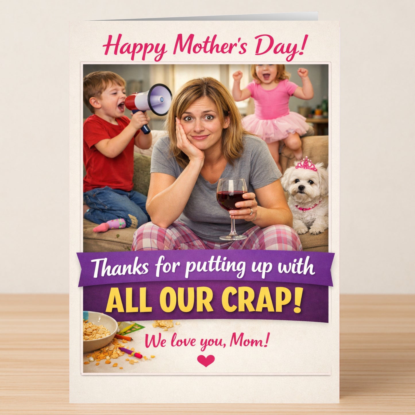 On the All Our Crap Mother's Day Card by Twisted Gifts, a tired woman relaxes with wine as playful kids and a dog create chaos—perfect for celebrating mom’s hectic life with humor.