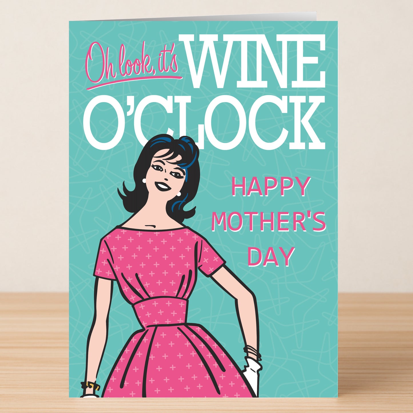 The Wine O'clock Funny Mother's Day Card by Twisted Gifts features a woman in a pink dress and the phrase "Oh look, it’s WINE O’CLOCK. HAPPY MOTHER'S DAY" on a cheerful teal background.