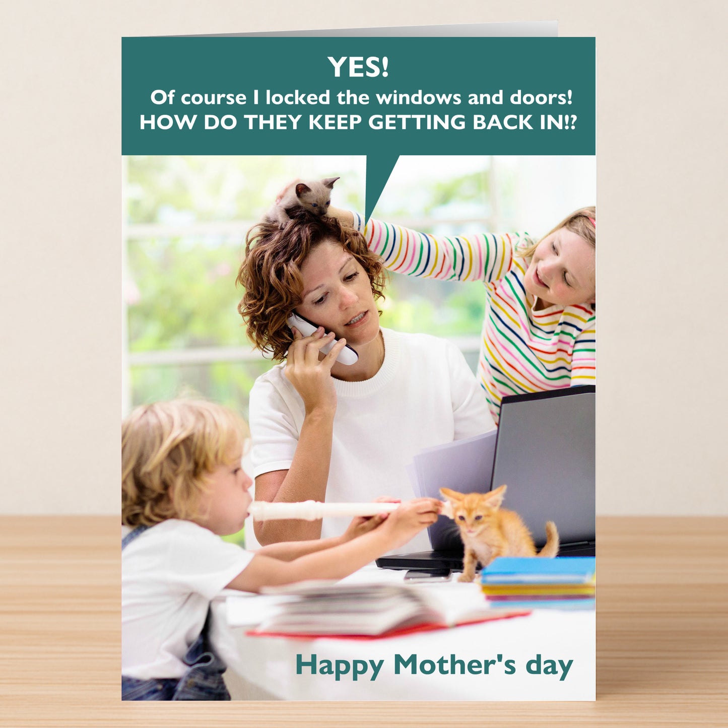 A frazzled mom juggles a call, laptop, and kitten as kids create chaos in this hilarious "Get Back In Funny Mother's Day Card" by Twisted Gifts. The front reads "Happy Mother's Day" with a witty speech bubble above her.