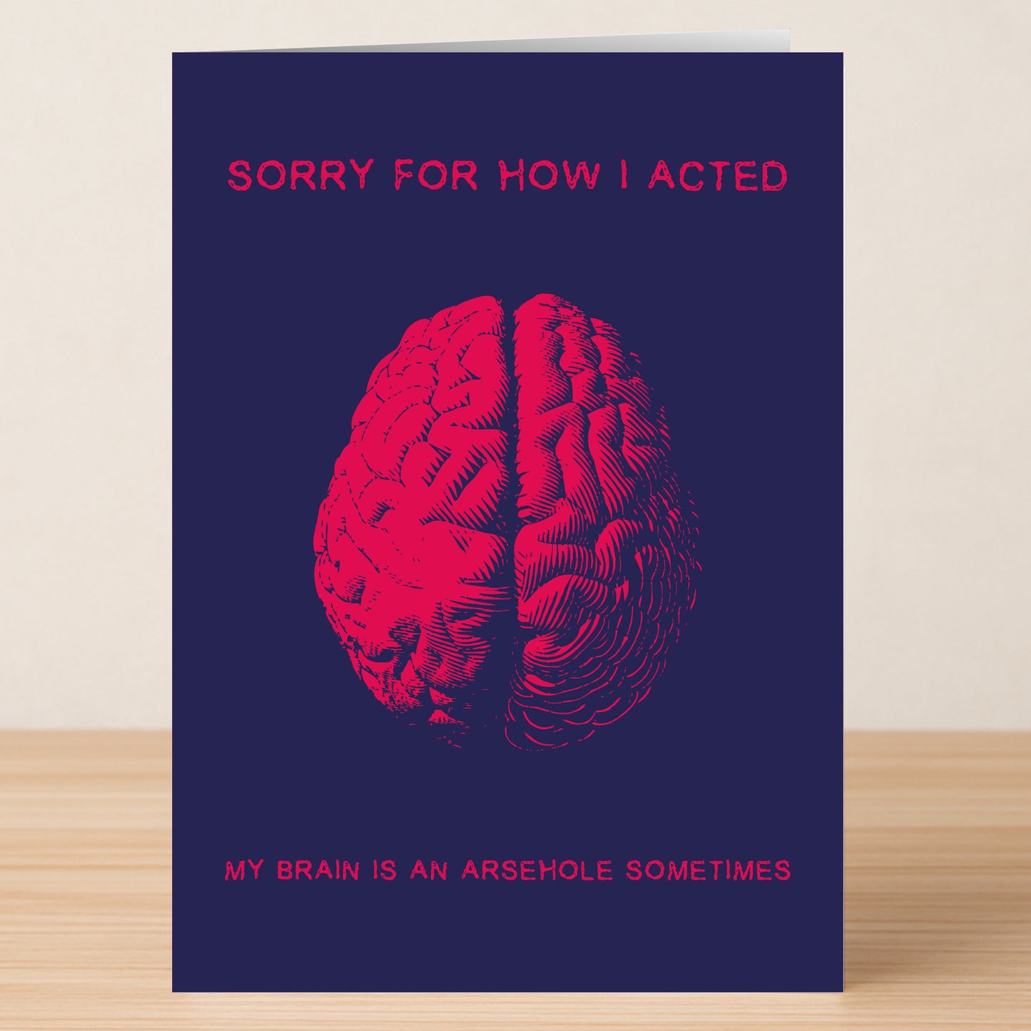 Arse Brain – Funny Sorry Card by Twisted Gifts: Features a red brain on a dark blue background with the text "Sorry for how I acted. My brain is an arsehole sometimes." A perfect sarcastic, rude apology card.