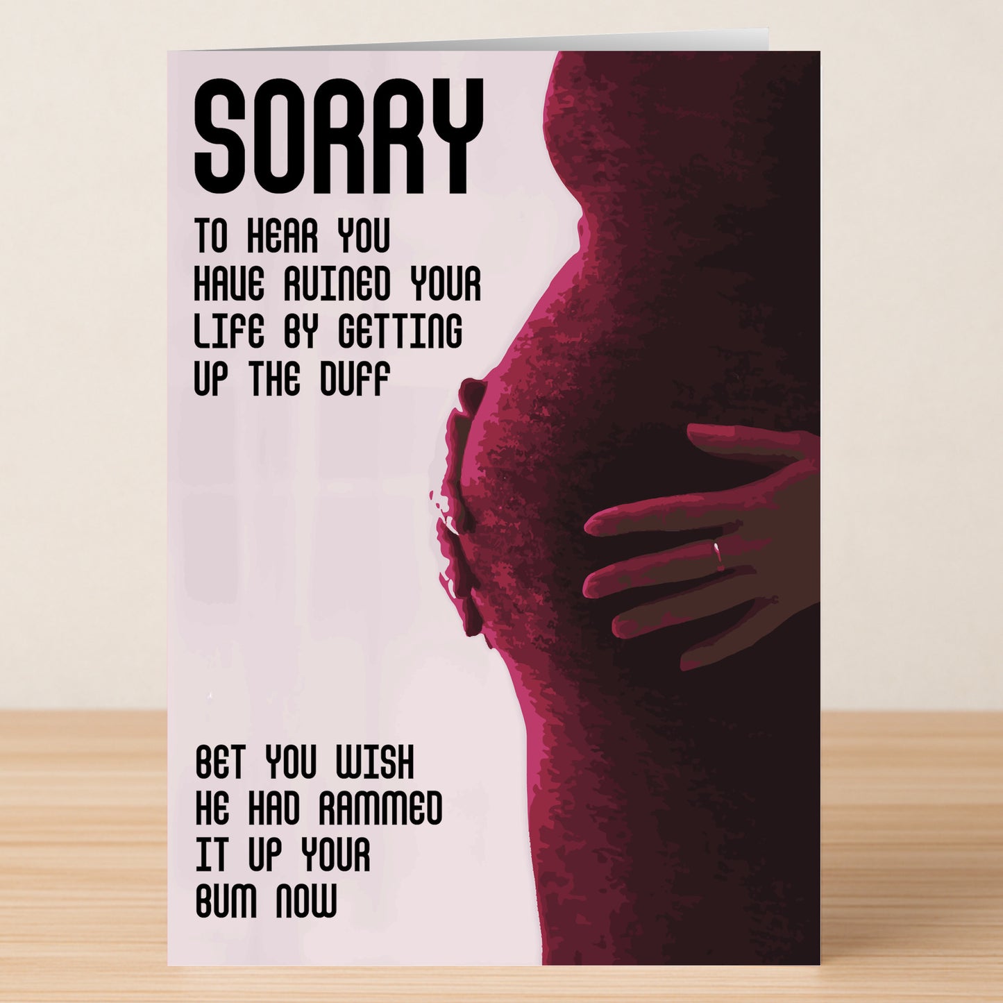 The Up The Duff – Rude Sorry Card by Twisted Gifts features a sarcastic message for pregnant friends: “Sorry to hear you have ruined your life by getting up the duff. Bet you wish he had rammed it up your bum now.”.