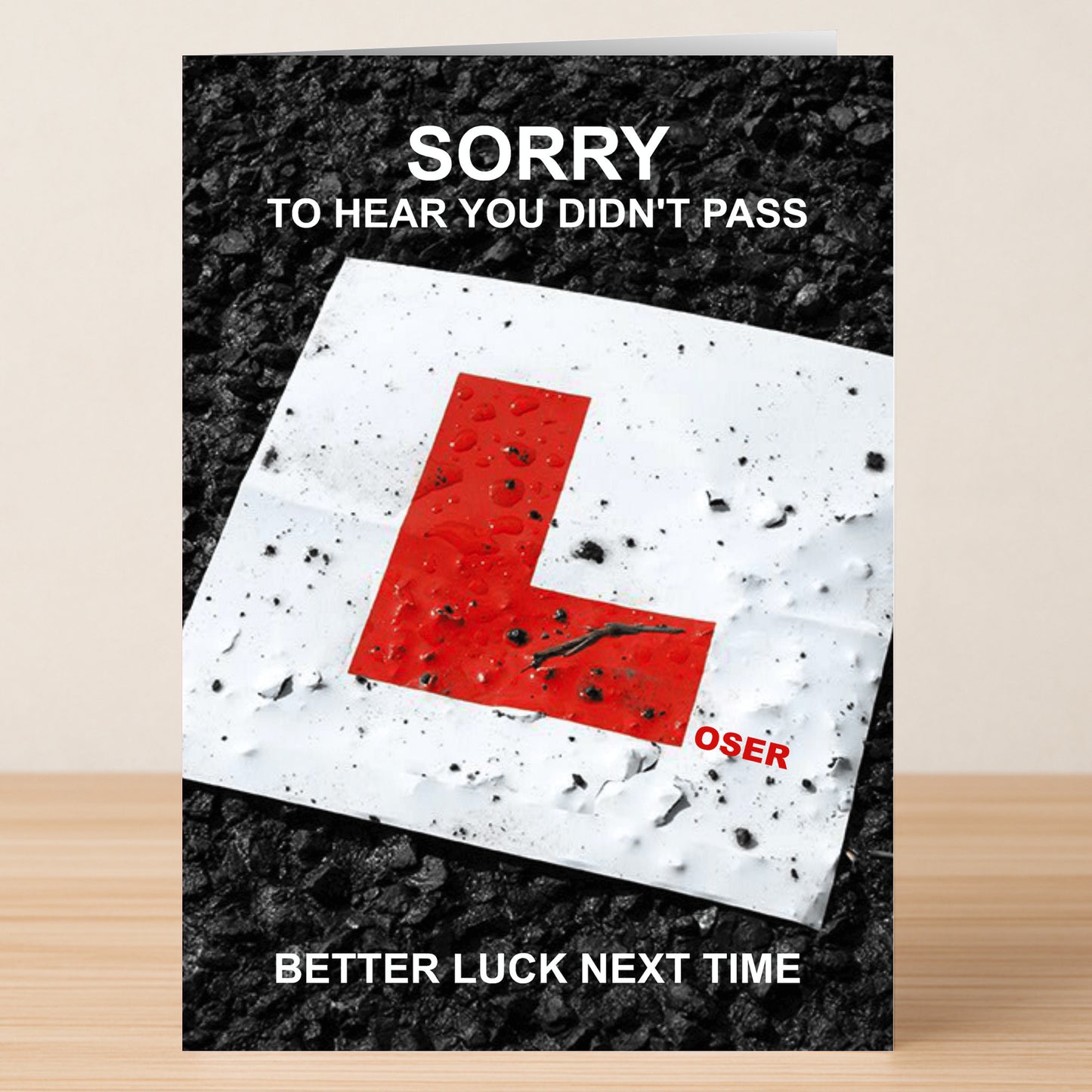 Twisted Gifts' "Loser – Insulting Sorry Card" shows a red "L" sign on wet pavement, with phrases like "Sorry to hear you didn't pass," "Better luck next time," and "Loser"—a perfect sarcastic sorry card.