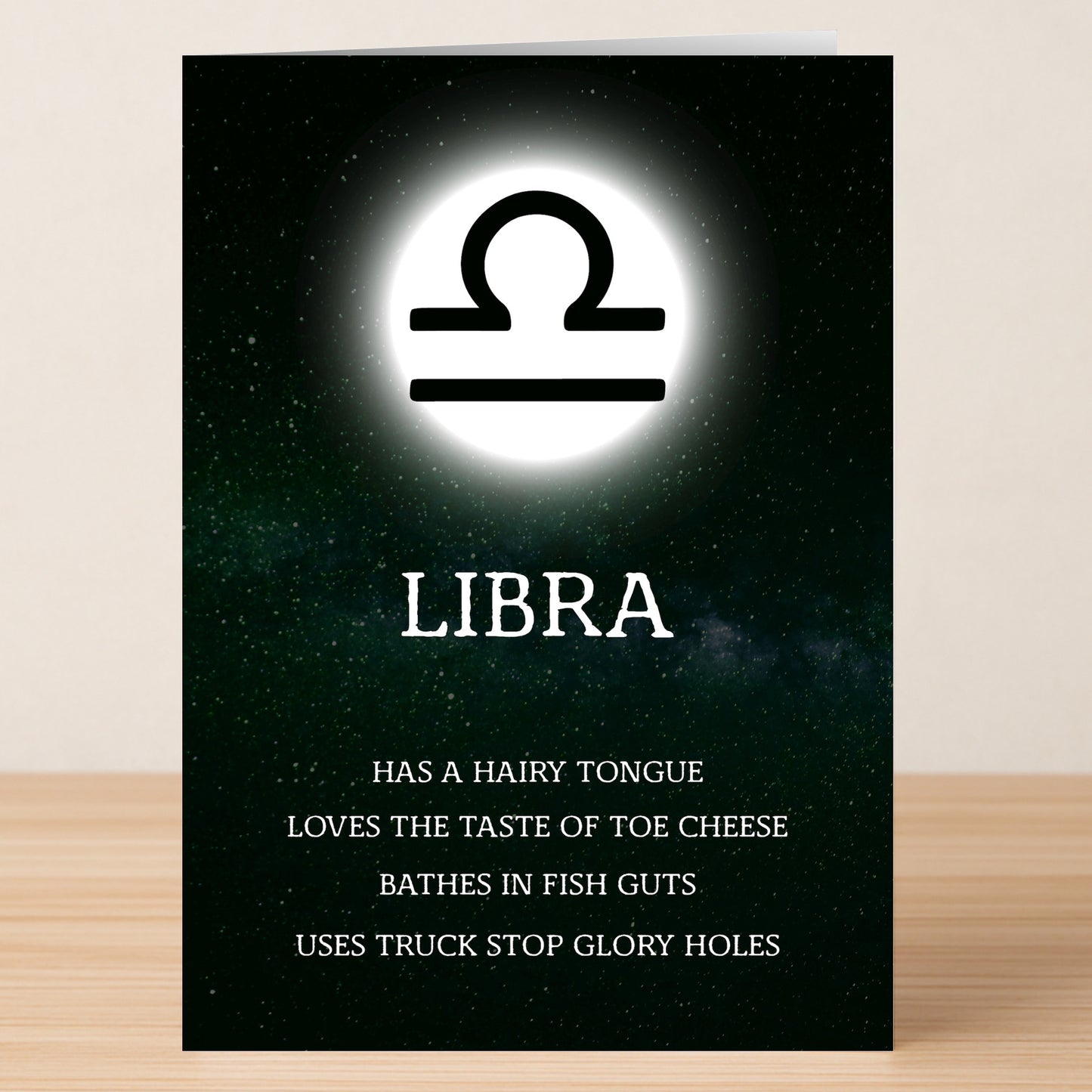 The Libra Rude Star Sign Card by Twisted Gifts showcases the zodiac symbol above "LIBRA," listing bold, cheeky traits below—a witty, irreverent gift with a starry background.