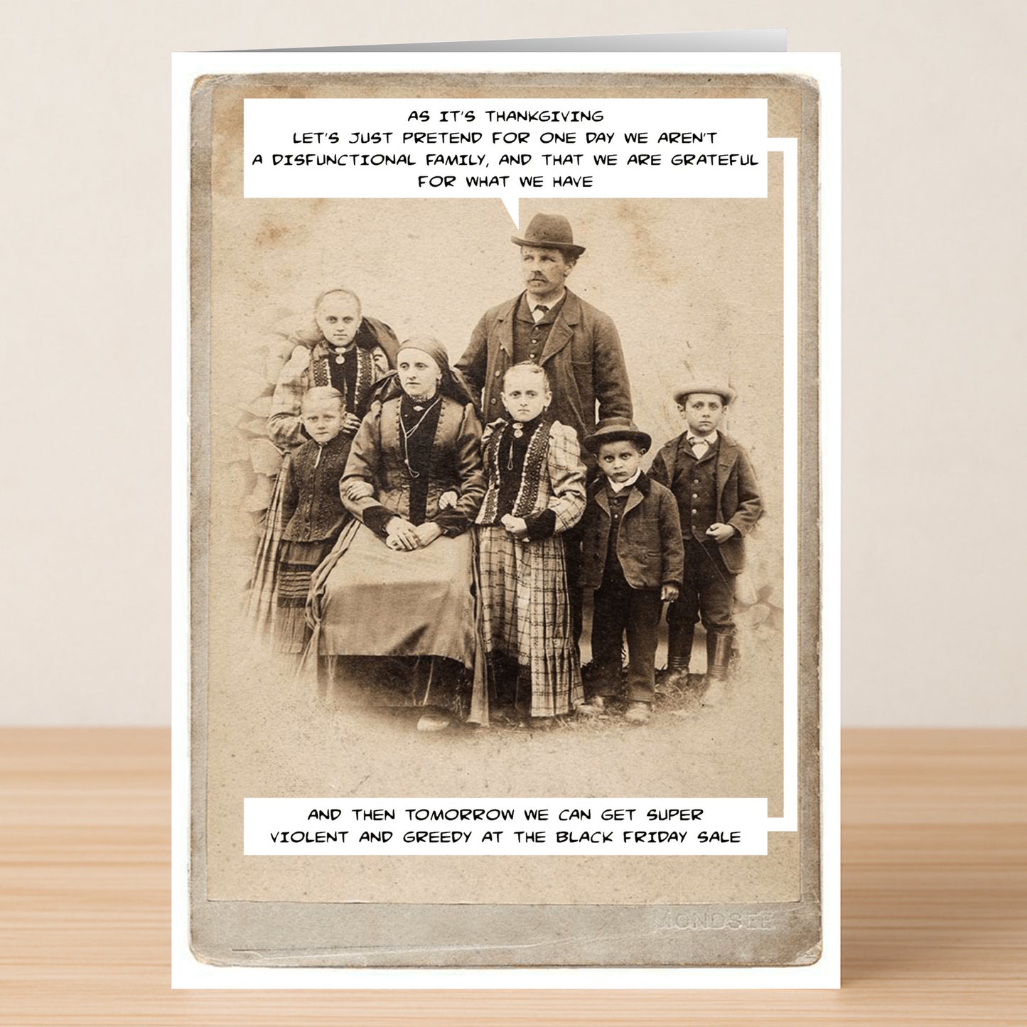 The Friday Sale Insulting Thanksgiving Card by Twisted Gifts features a vintage family portrait with the text, "Let's pretend for one day we aren't a dysfunctional family," making it perfect for those who love funny, cheeky holiday cards.
