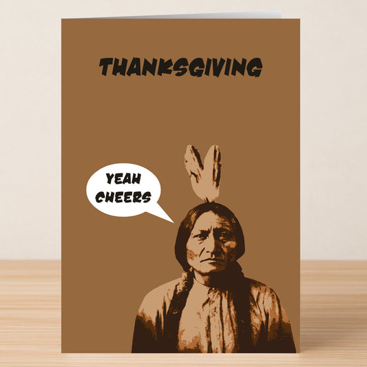 The Yeah Cheers Funny Thanksgiving Card by Twisted Gifts features "THANKSGIVING" on top and a sepia-toned Native American man saying "YEAH CHEERS"—a humorous greeting card perfect for Thanksgiving.