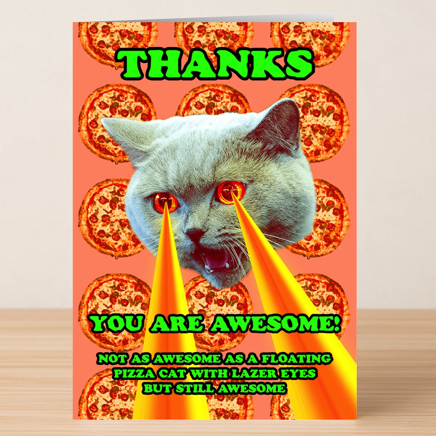 The Lazer Cat Insulting Thank You Card by Twisted Gifts features a cat head with laser eyes floating before repeating pizza slices, plus the message: "THANKS. YOU ARE AWESOME! Not as awesome as a floating pizza cat with lazer eyes, but still awesome.