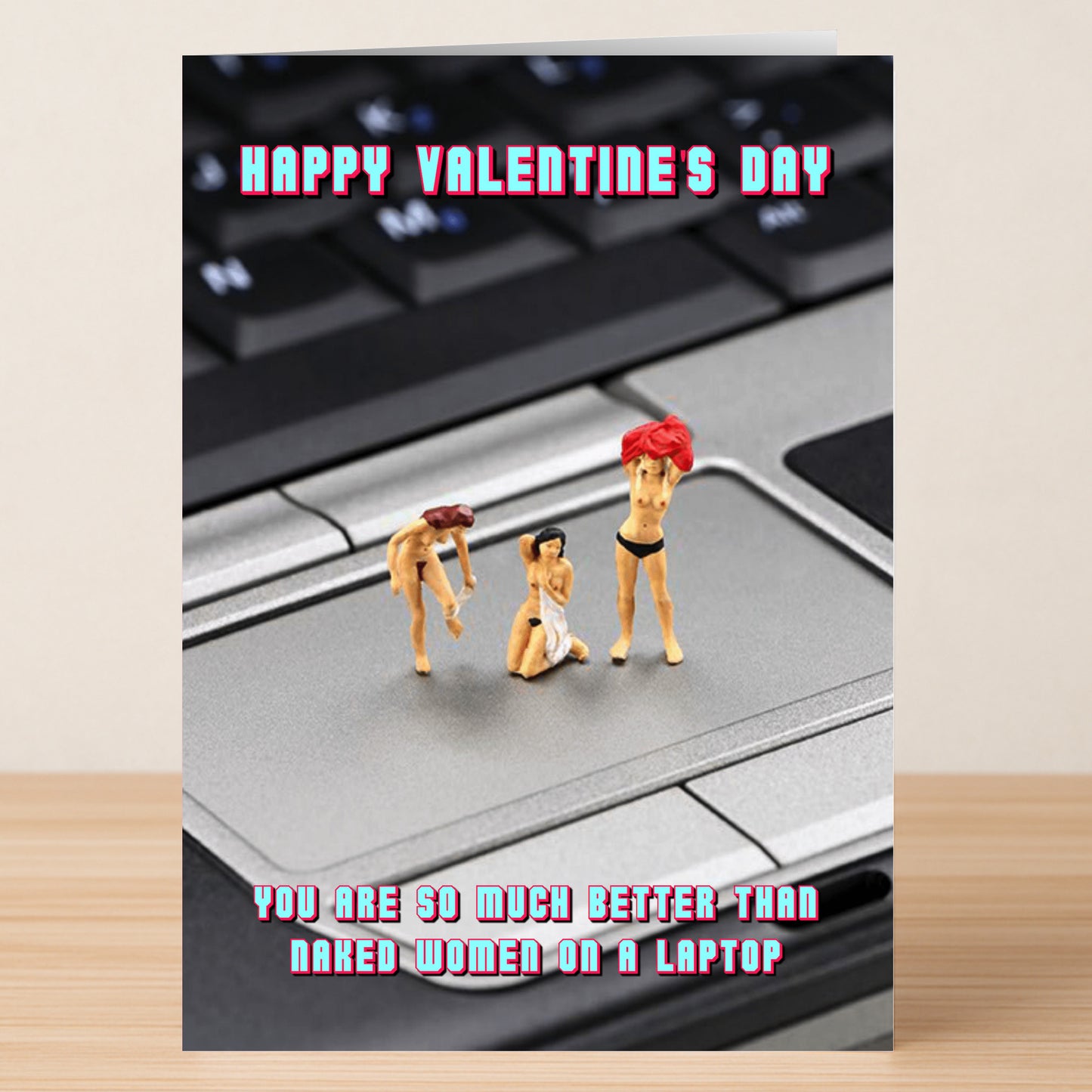 Twisted Gifts’ Laptop Funny Valentine’s Card features three nude women figurines on a laptop, with the message: “Happy Valentine’s Day. This card says you’re so much better than naked women on a laptop.”.