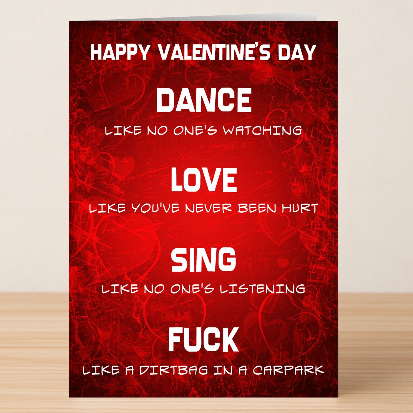 The Carpark Funny Valentine’s Card by Twisted Gifts features a bold red design with white text: “Dance like no one’s watching, Love like you’ve never been hurt, Sing like no one’s listening, Fuck like a dirtbag in a carpark.”.