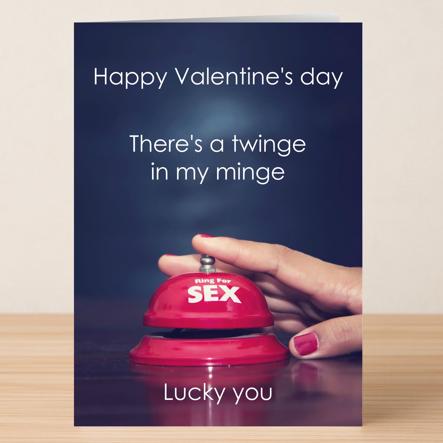 A hand with pink nail polish presses a red "Ring for SEX" bell on the Twisted Gifts Minge Funny Greeting Card featuring the message: "Happy Valentine's Day. There's a twinge in my minge. Lucky you.