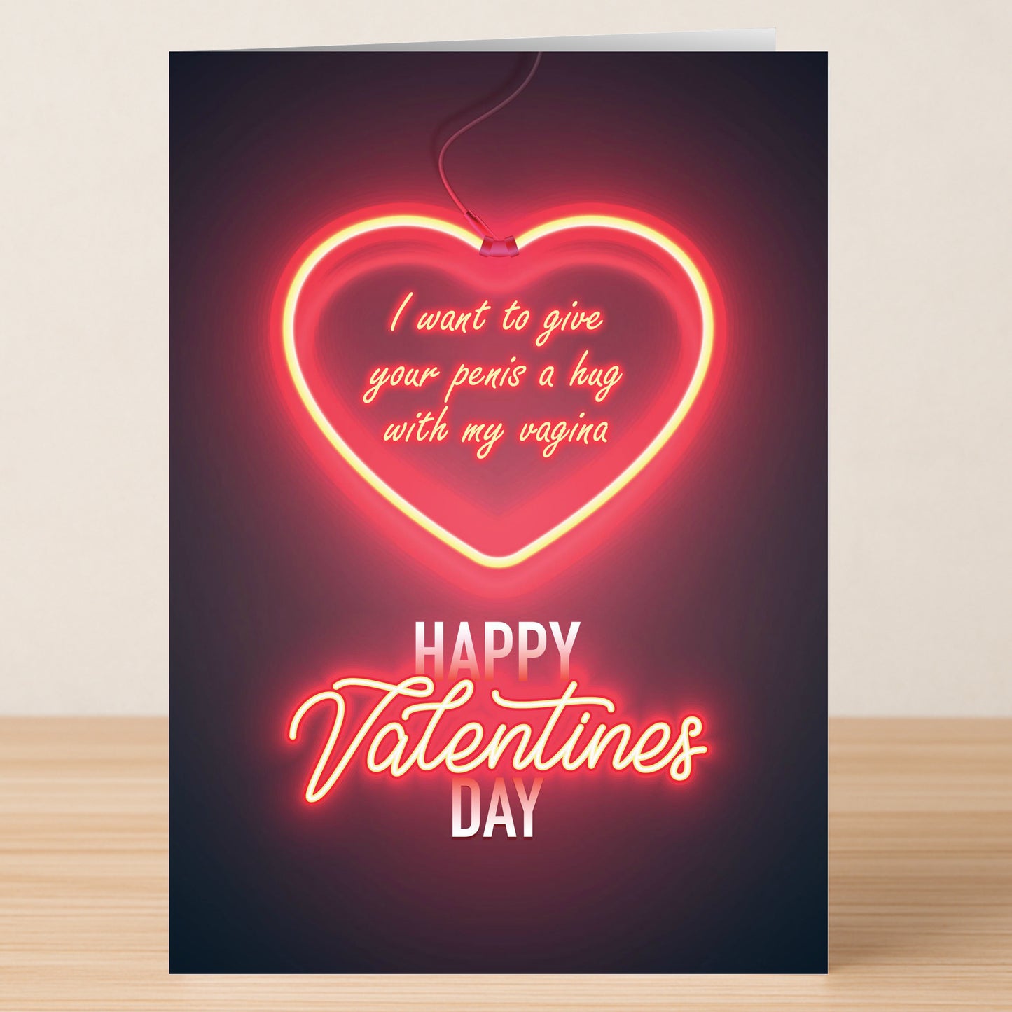 The Hug Rude Valentines Card by Twisted Gifts features a neon heart and bold, cheeky message: "I want to give your penis a hug with my vagina. Happy Valentines Day." Perfect for anyone who loves offbeat humor on Valentine’s Day!.