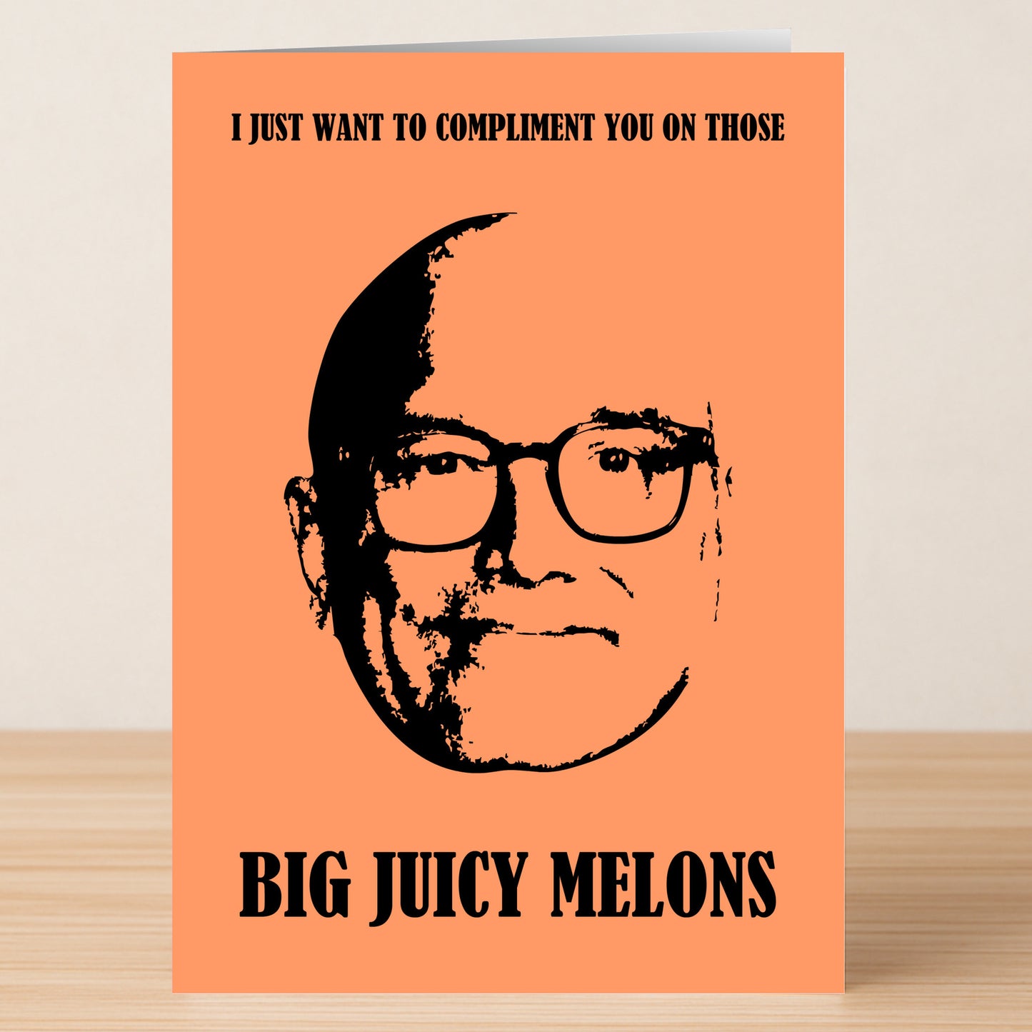 The Melons Rude Valentines Card by Twisted Gifts is orange and features a black-and-white drawing of a man's face with the funny message, "I just want to compliment you on those big juicy melons.