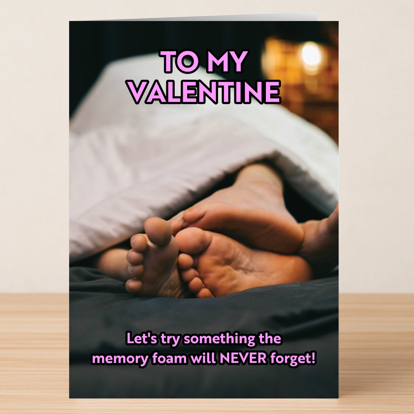 The Memory Foam Rude Valentines Card by Twisted Gifts features two pairs of feet tangled under a blanket with "TO MY VALENTINE" and the cheeky line, "Let's try something the memory foam will NEVER forget!.