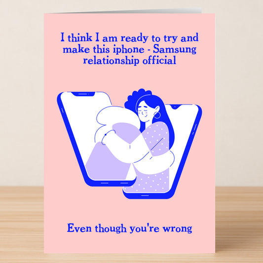 The Official Rude Valentines Card by Twisted Gifts delivers humor with two people hugging from phones and the message: "I think I am ready to make this iPhone - Samsung relationship official. Even though you're wrong.