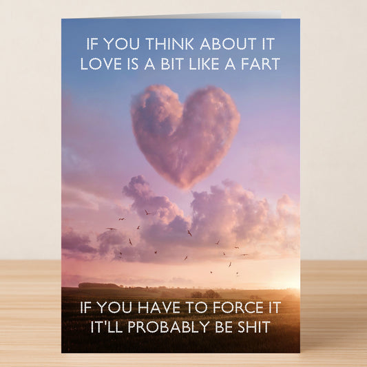 A Fart Funny Valentines Card by Twisted Gifts—features a heart-shaped cloud at sunset and playful text comparing love to a fart: laugh, don't force it, or it'll lead to trouble!.