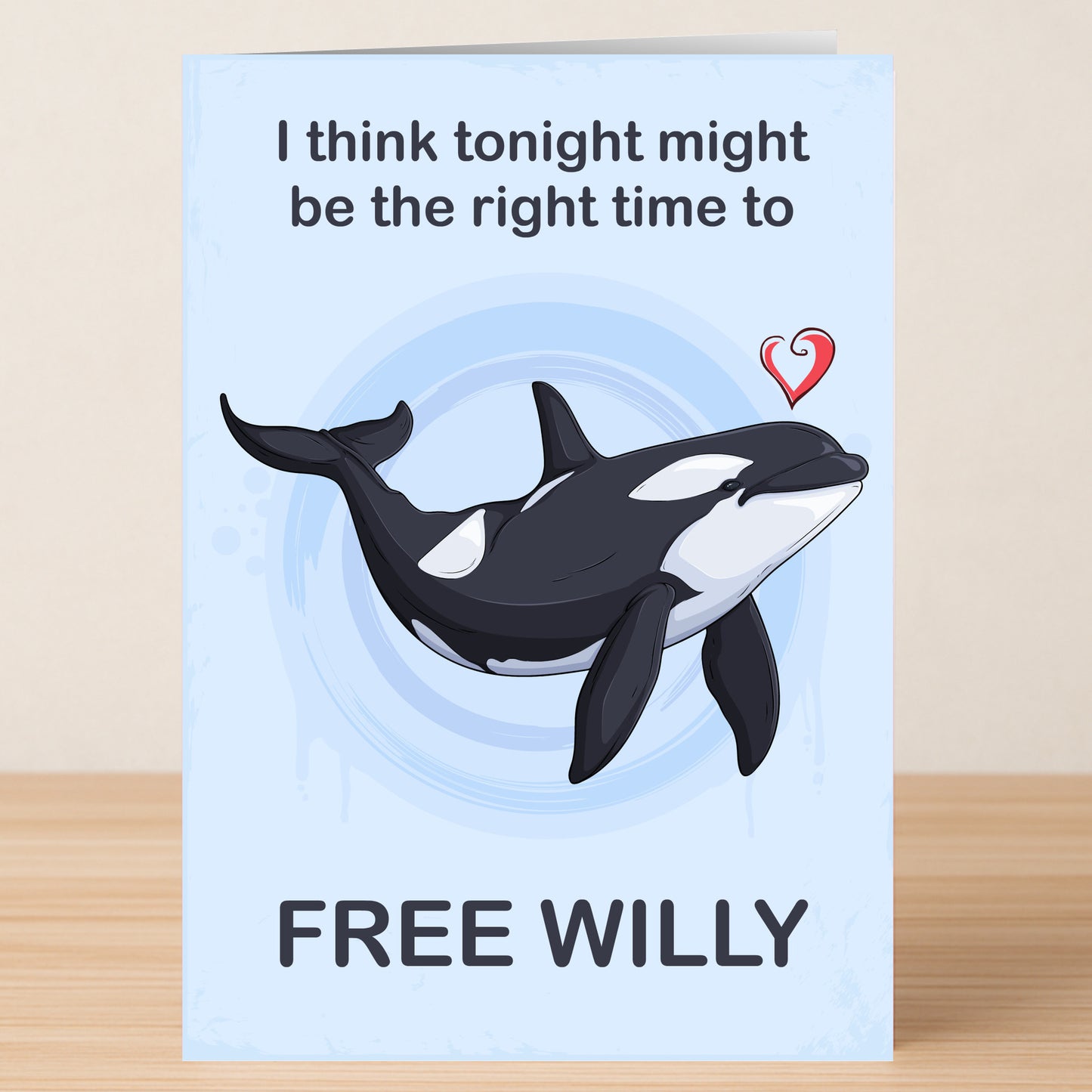 The Free Willy Valentines Card by Twisted Gifts features an orca whale with a red heart and the words "I think tonight might be the right time to FREE WILLY." A funny Valentine’s Day card for whale lovers!.