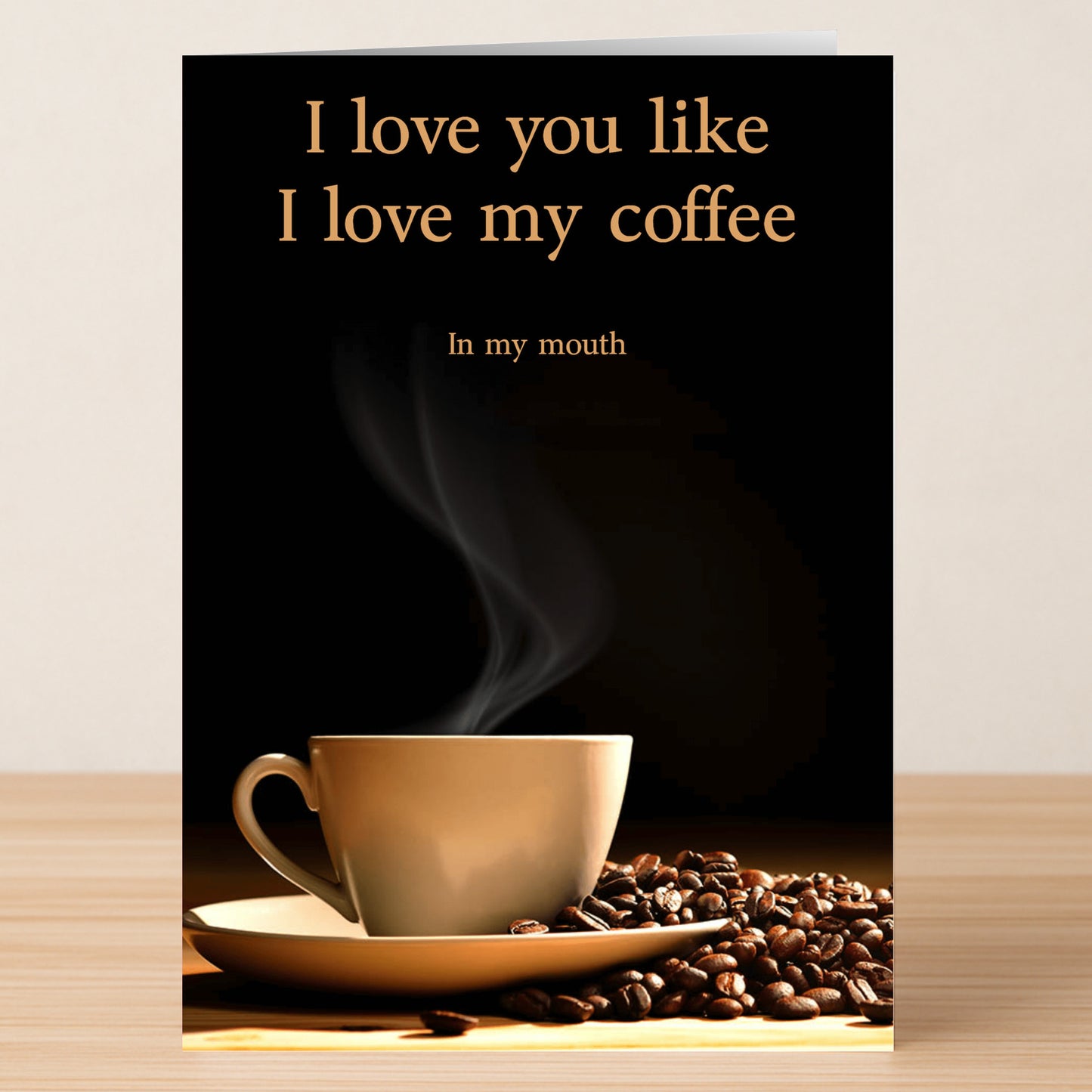 The Love My Coffee Rude Greeting Card by Twisted Gifts features a steaming coffee cup with beans and the cheeky message, "I love you like I love my coffee: In my mouth." Perfect for coffee lovers with a sense of humor.