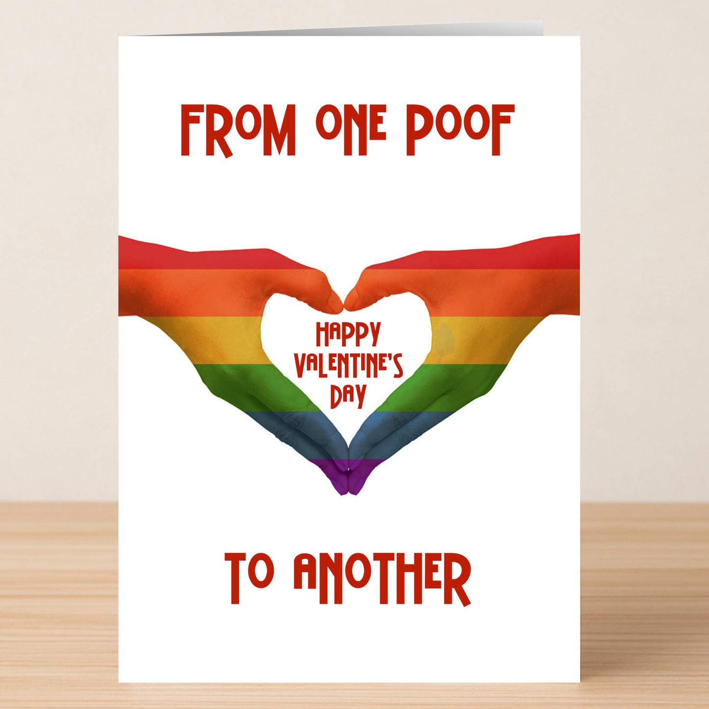The One Poof Funny Valentine's Card by Twisted Gifts features two hands forming a rainbow-striped heart and the message "From one poof to another, Happy Valentine's Day" in red text, perfect for a quirky celebration.