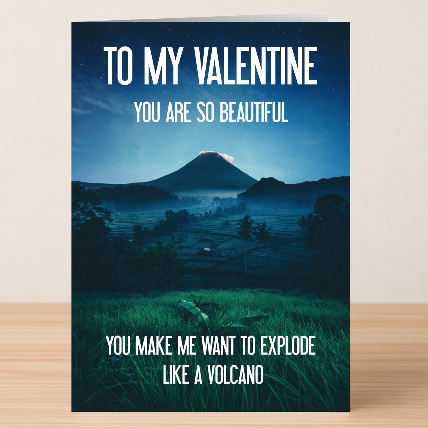 The Volcano Rude Valentine's Card by Twisted Gifts features a volcano with green grass and the message: "To my Valentine, you are so beautiful, you make me want to explode like a volcano." Perfect for a humorous Valentine's Day.