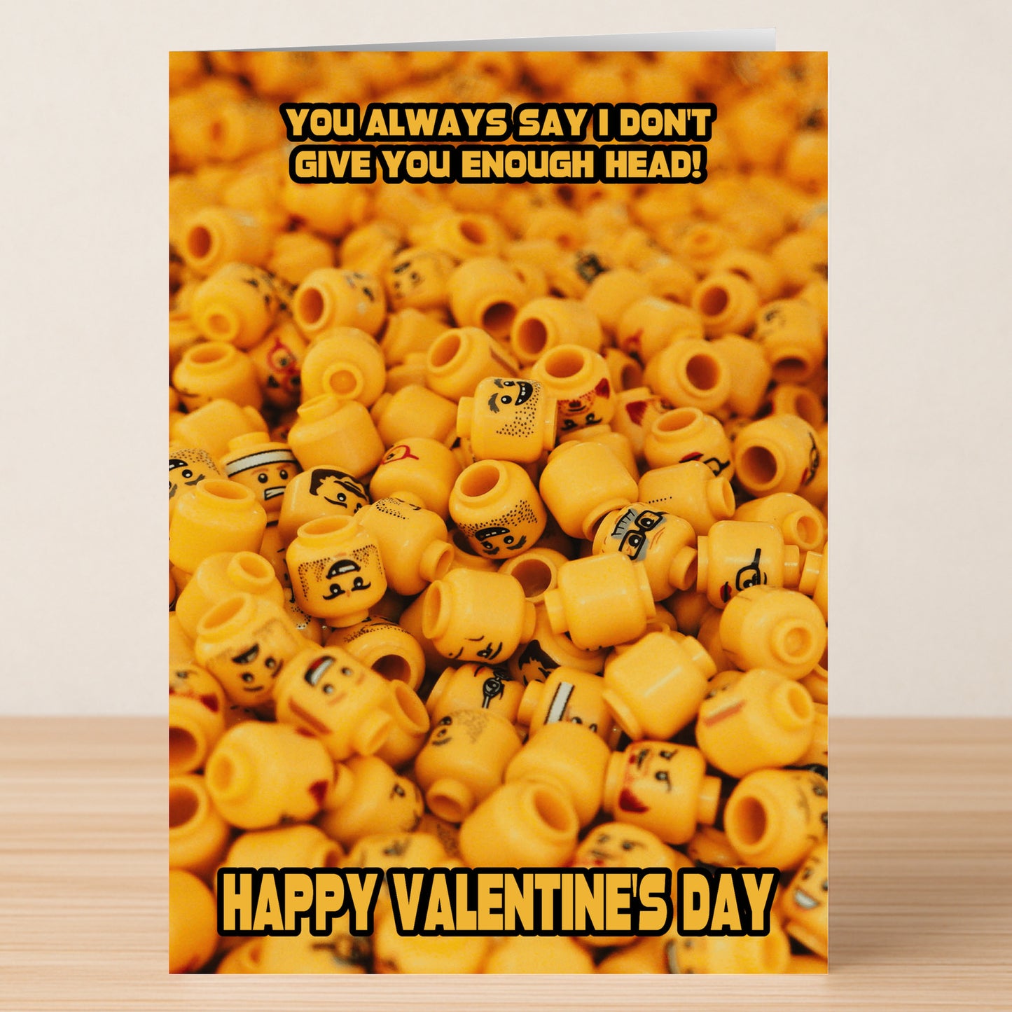 The Not Enough Head Rude Valentine's Card by Twisted Gifts features a stack of LEGO minifigure heads and the bold message, "You always say I don't give you enough head! Happy Valentine's Day." Ideal for those who love cheeky humor.