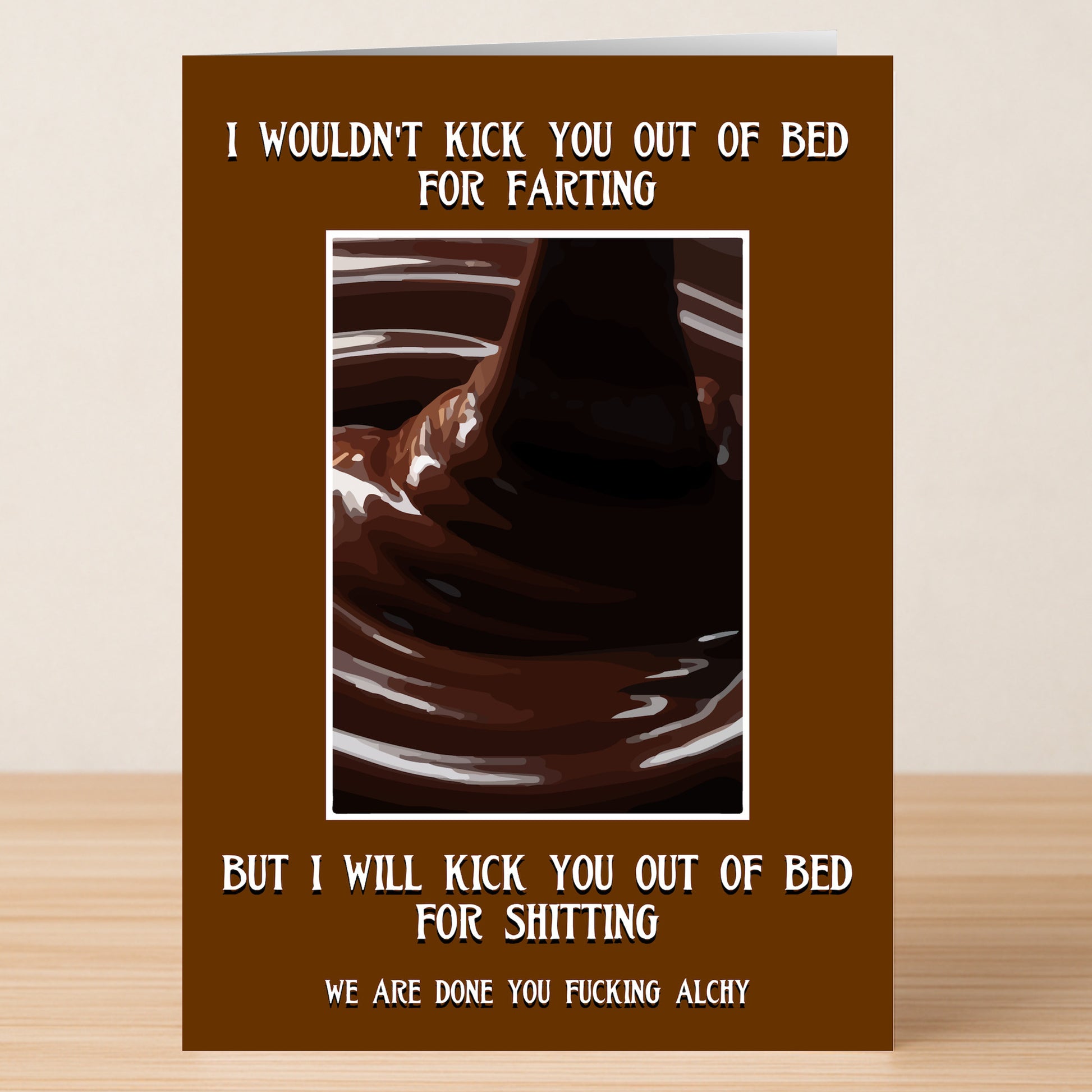 The Kick You Out Of Bed Rude You're Dumped Card from Twisted Gifts features chocolate being poured on a brown background with cheeky, explicit breakup humor—ideal for giving tough love and laughs.