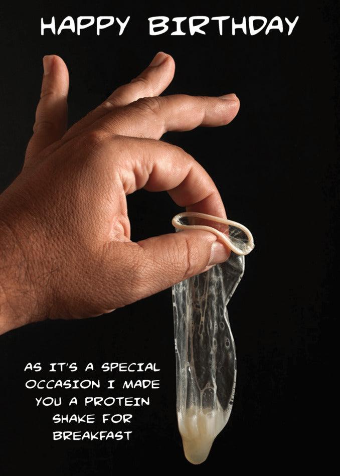 A hand holding a plastic bag with a Twisted Gifts Protein Shake Rude Birthday Card.