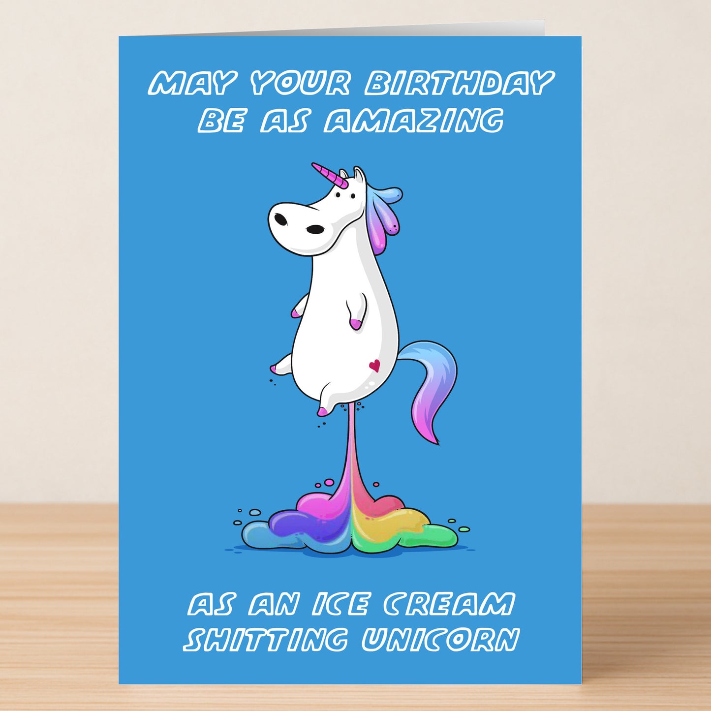 The Unicorn – Funny Birthday Card by Twisted Gifts features a cartoon unicorn pooping rainbow ice cream and the cheeky text: “May your birthday be as amazing as an ice cream shitting unicorn.” Ideal for fans of rude humor!.