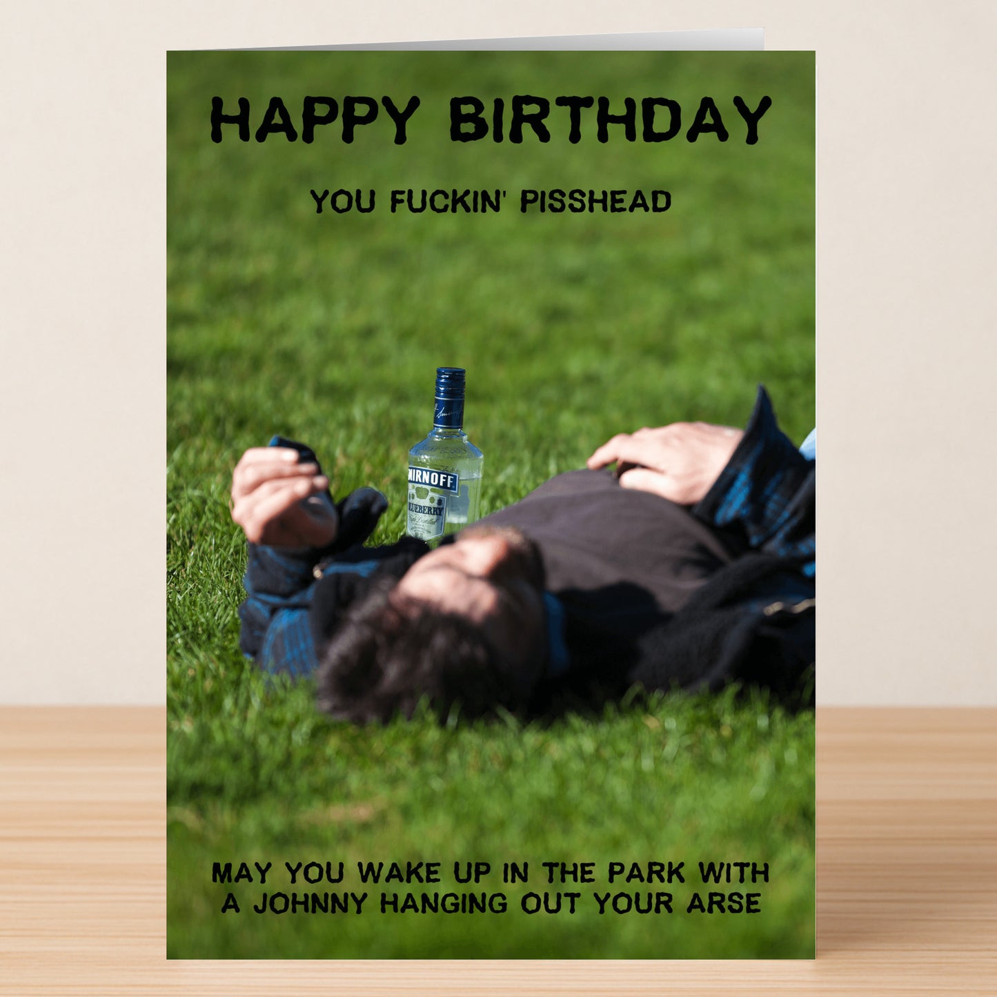 The Pisshead – Rude Birthday Card by Twisted Gifts shows a person lying on grass next to a vodka bottle, with bold, vulgar birthday wishes—perfect for anyone who loves funny, rude cards.
