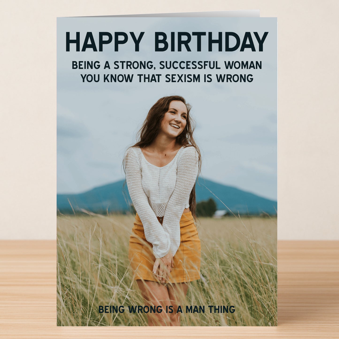 The "Sexism Her – Funny Birthday Card" by Twisted Gifts features a smiling woman in a field with witty, sarcastic text about sexism and a playful birthday greeting.