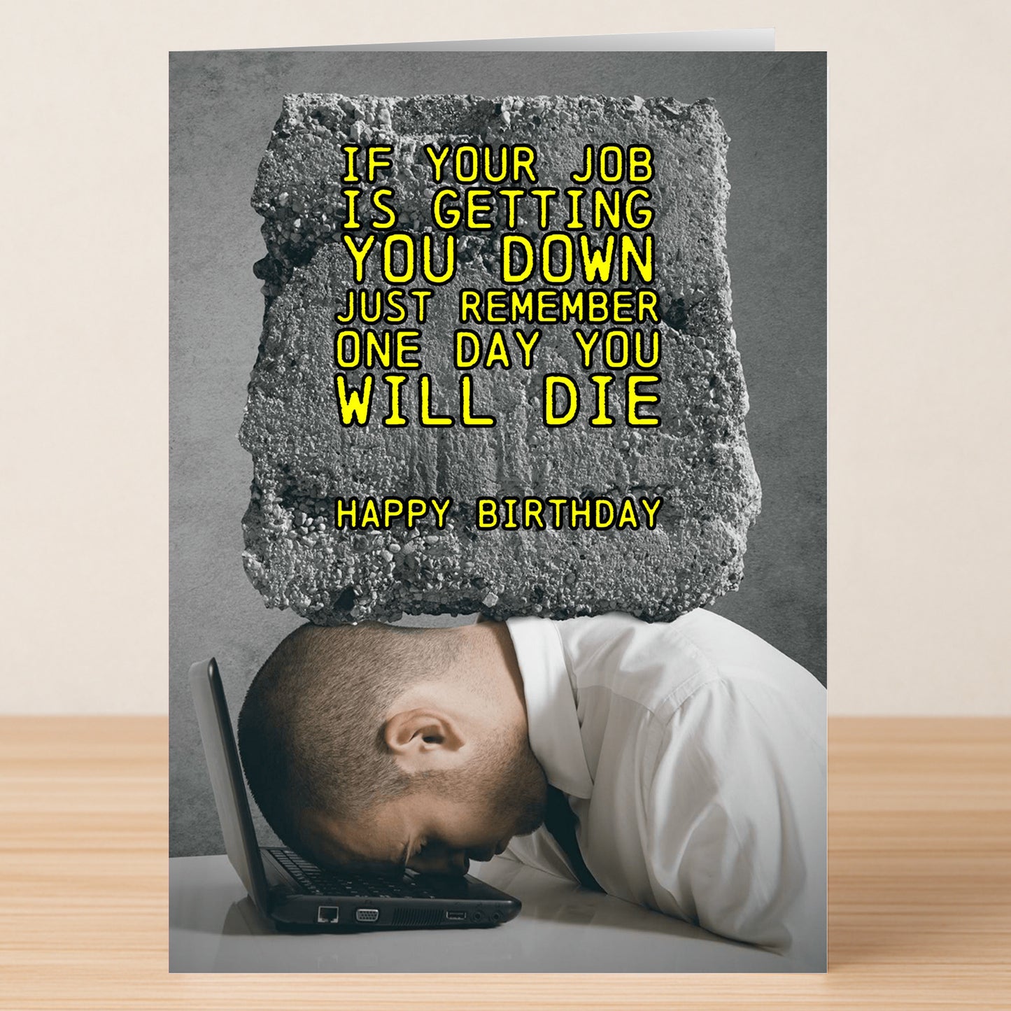 A man rests his head on a laptop with the text: "If your job is getting you down just remember one day you will die. Happy Birthday." One Day – Dark Humour Birthday Card by Twisted Gifts, perfect for fans of edgy, offensive cards.