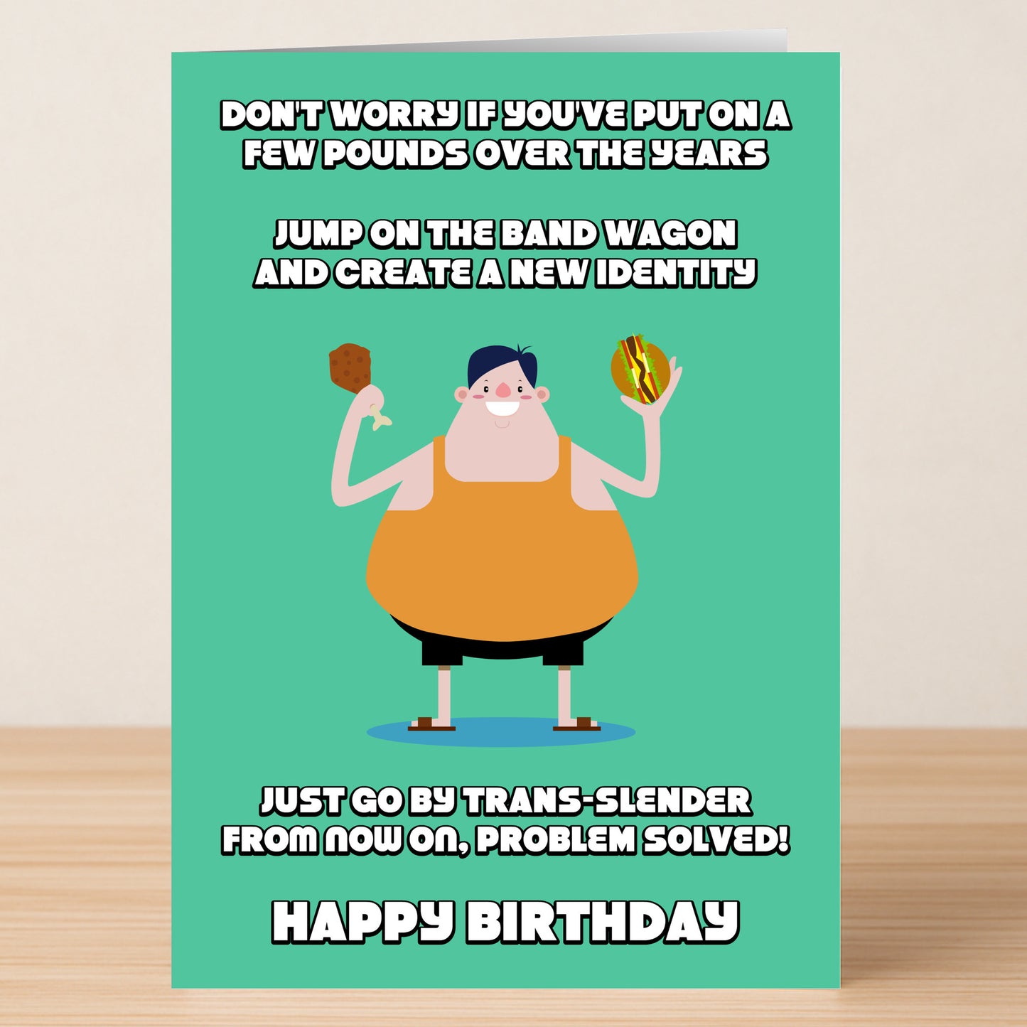 The Trans Slender – Funny Birthday Card by Twisted Gifts features a cartoon person in an orange tank top holding a meat stick and a hamburger, with a humorous message about gaining weight and creating a new identity.