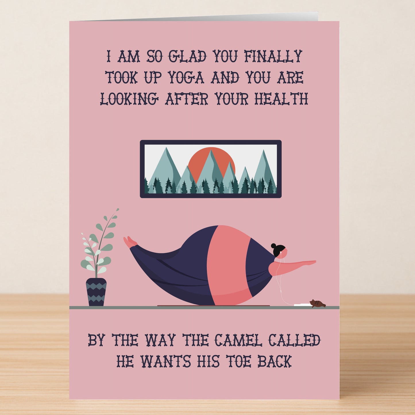 The Camel – Insulting Birthday Card by Twisted Gifts shows a woman doing yoga with her dog, joking about her flexibility and teasing that even a camel wants his toe back—a hilariously offensive birthday greeting!.