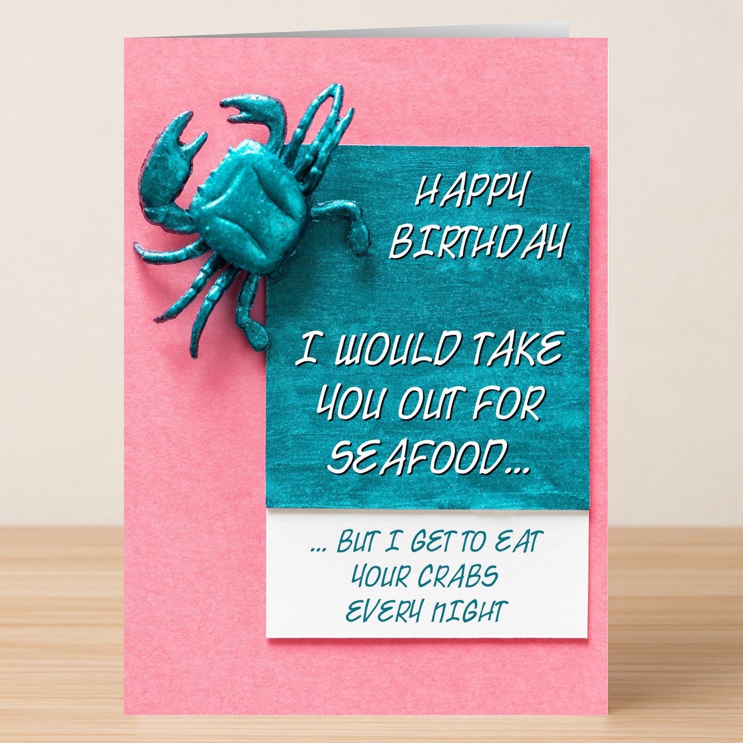 The Out For Seafood – Rude Birthday Card by Twisted Gifts features a teal crab and the cheeky message: "Happy Birthday. I would take you out for seafood... but I get to eat your crabs every night." Perfect for those who love rude humor!.