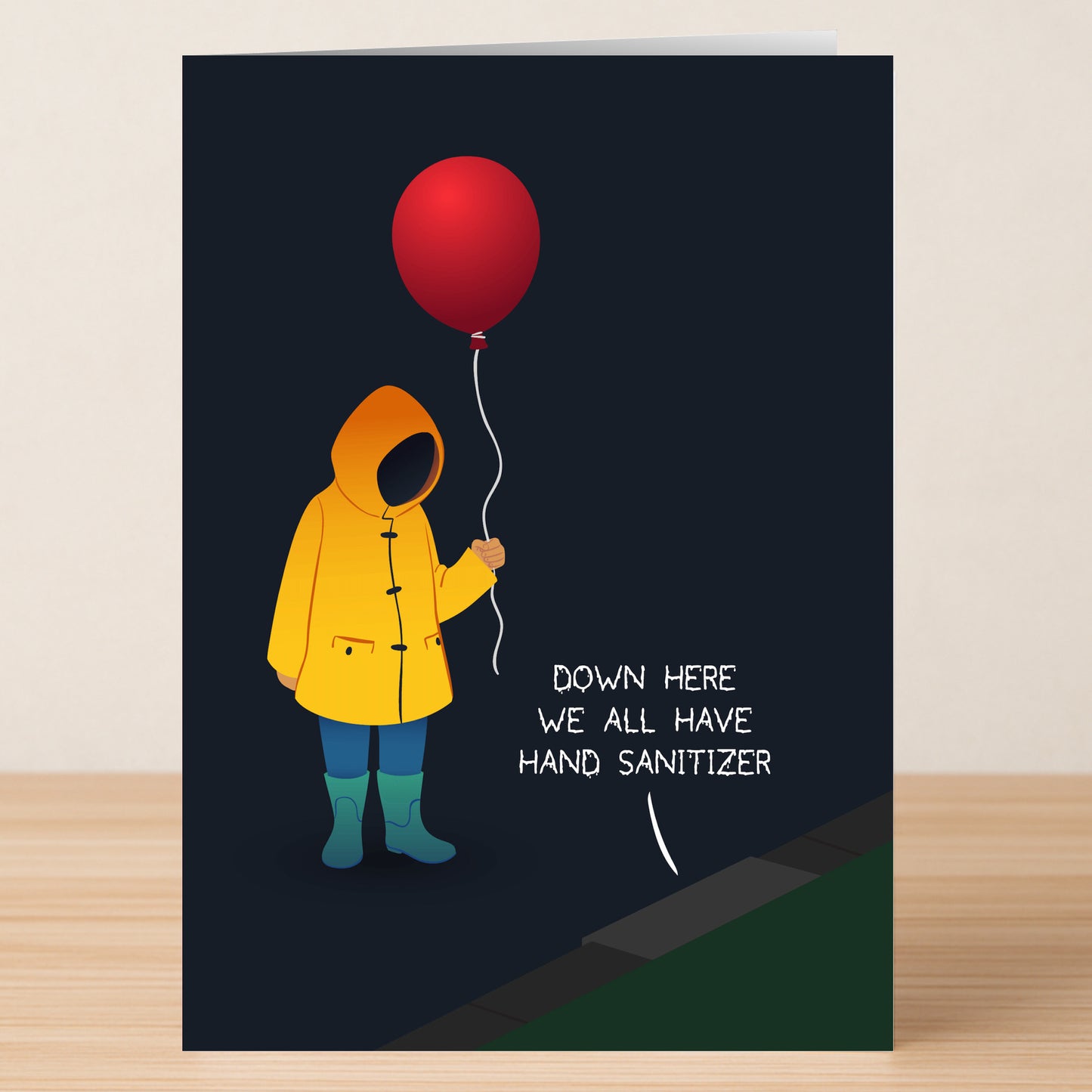 Sanitizer – Dark Humour Birthday Card by Twisted Gifts: Features a person in a yellow raincoat and boots holding a red balloon with the text "Down here we all have hand sanitizer"—ideal for fans of cheeky birthday humor.