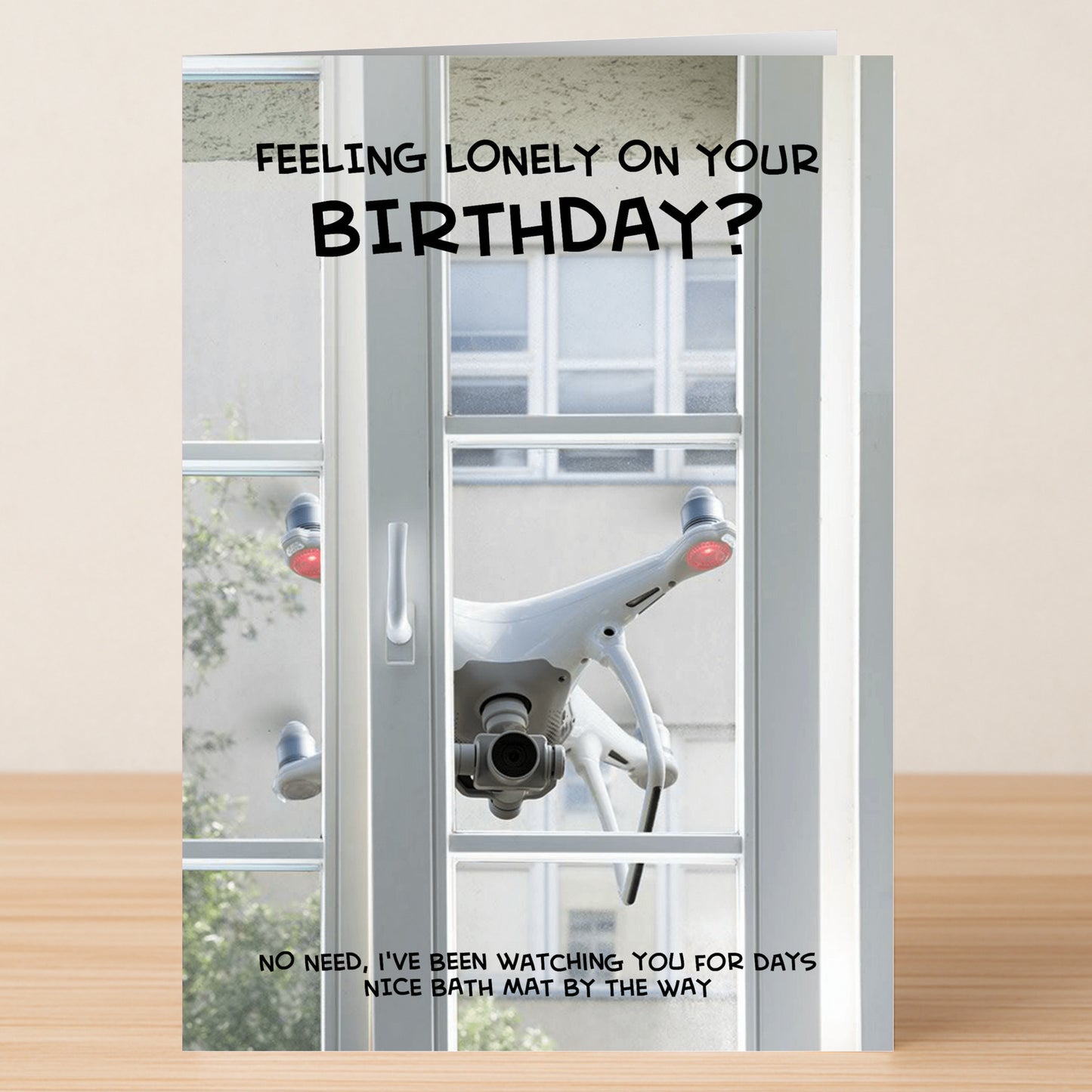 Twisted Gifts’ Bath Mat – Dark Humour Birthday Card features a drone outside a window with witty text, perfect for anyone who loves a laugh and appreciates quirky humor on their birthday.
