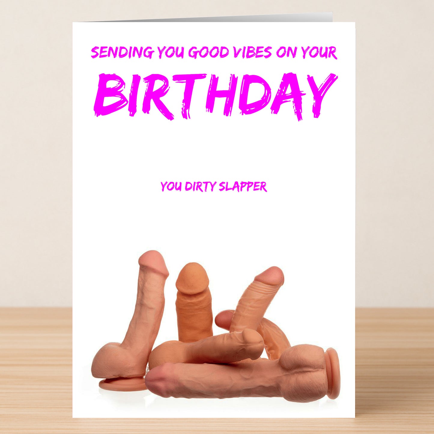 The Dirty Slapper – Rude Birthday Card by Twisted Gifts features “Sending you good vibes on your birthday. You dirty slapper” above silicone penis models—a hilariously cheeky card for anyone with an outrageous sense of humor!.