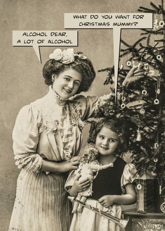 A woman and a little girl standing next to a Christmas tree, holding Twisted Gifts' Alcohol Dear Funny Christmas Card and posing for a funny Christmas card.