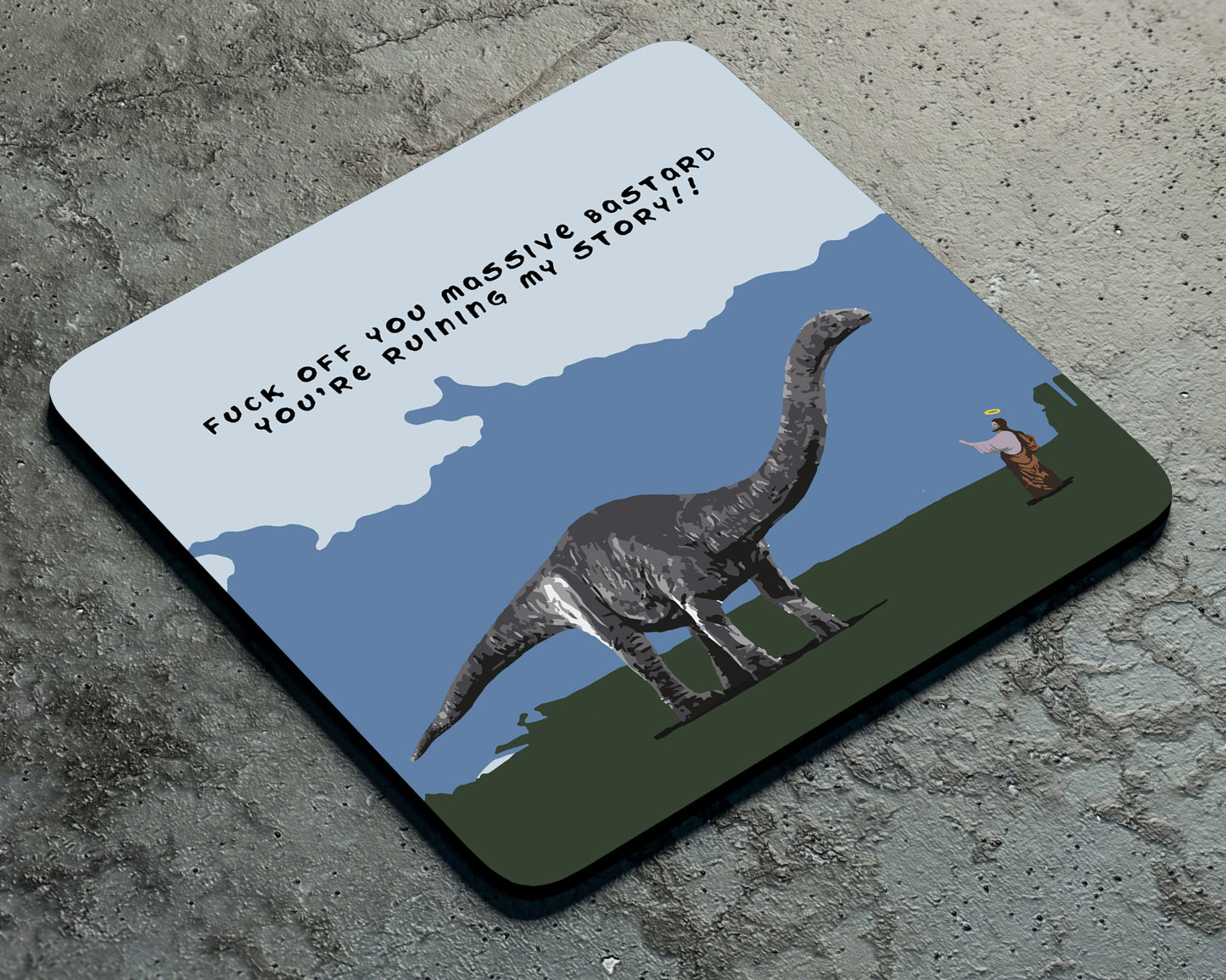 The Dino Jesus Coaster by Twisted Gifts features a big dinosaur and person with "FUCK OFF YOU MASSIVE BASTARD YOU'RE RUINING MY STORY!!"—a hilarious, irreverent gift for fans of sacrilegious comedy.